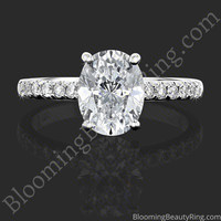 The Oval Embrace hidden halo diamond engagement ring laying down, showing the oval center and the diamond band, BBR742E