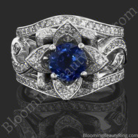 The Large Lotus Swan Double Band Flower Ring Set – bbr626-1 with a blue sapphire center laying down