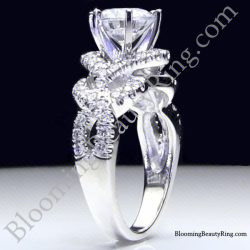Round diamond engagement ring standing up, six prongs above a crossover band of pave set diamonds - bbr595