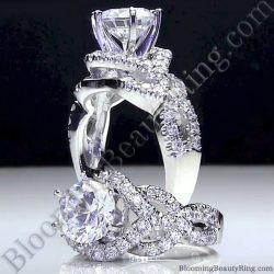Round diamond engagement ring standing up, six prongs above a crossover band of pave set diamonds - bbr595