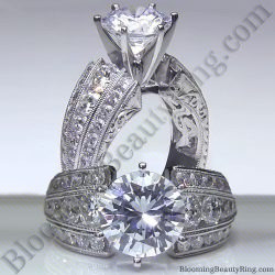 Round diamond engagement ring with an artisan etched euroshank, hand carved scroll work and channel set diamonds along both sides - bbr505