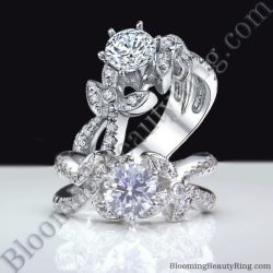 Nature inspired lotus flower engagement ring with a round center diamond, diamond set leaves and a split shank curving away like a stem - bbr548