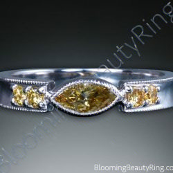 Marquise fancy yellow diamond set between two round yellow diamonds on a curved milgrain edged white gold band - cgrRG7164