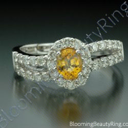 Oval yellow sapphire framed by a diamond halo on a waving split band of pave set diamonds - cgrRG192