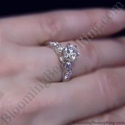 Tiffany style engagement ring with a large round center diamond and three graduated round diamonds along each side of the band - bbr5544e-1